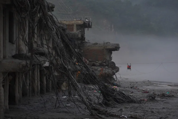Nepal holds a day of mourning after floods kill at least 1,300 people